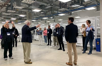 A group of Lab Design Conference attendees attending a behind-the-scenes lab tou