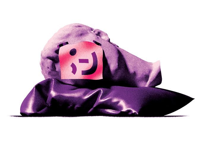 Fainting bust on a pillow with a winky emoticon on a sticky note covering its face