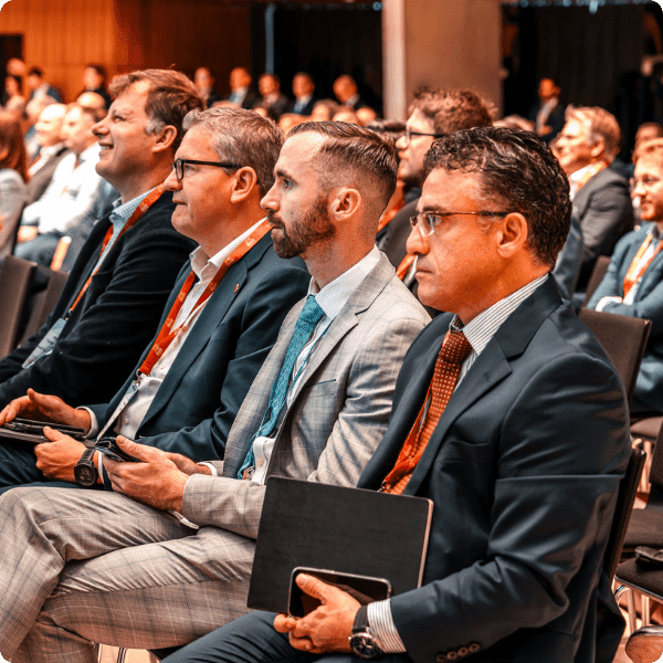 2 men in suits discussing at the European Captive Forum 2023