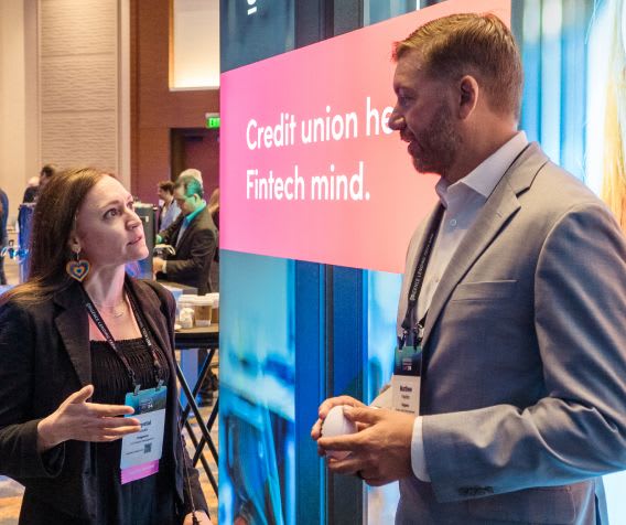 Attendees converse in the exhibit hall at Lending Tech Live