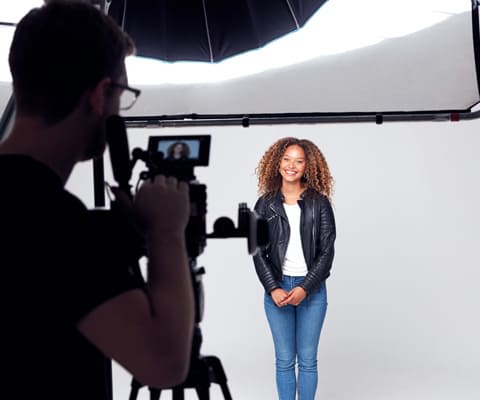 Two women sitting on a vendor panel at the Lab Manager Leadership Summit. One is speaking into the microphone and the other is holding a notebook