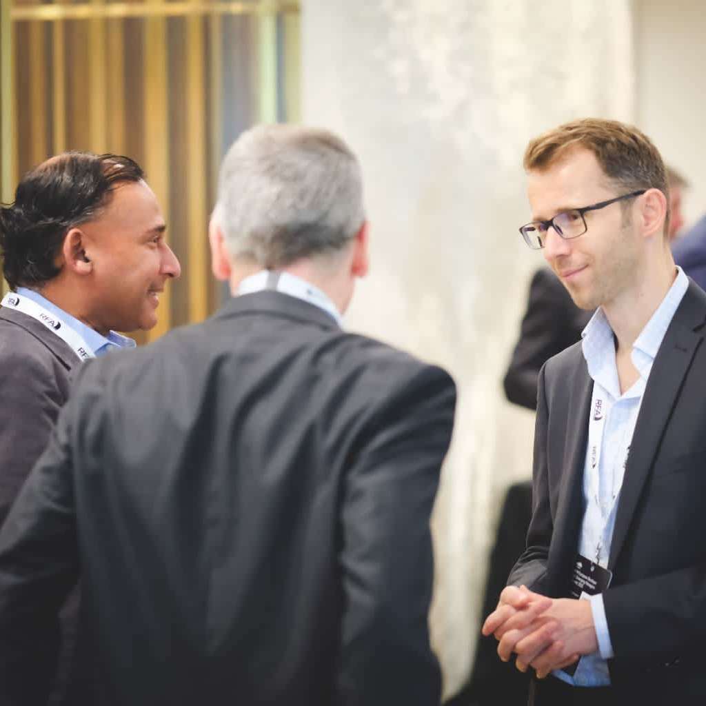 Senior managers making connections and shaking their hands at the HFM European Boutique and Emerging Managers Summit