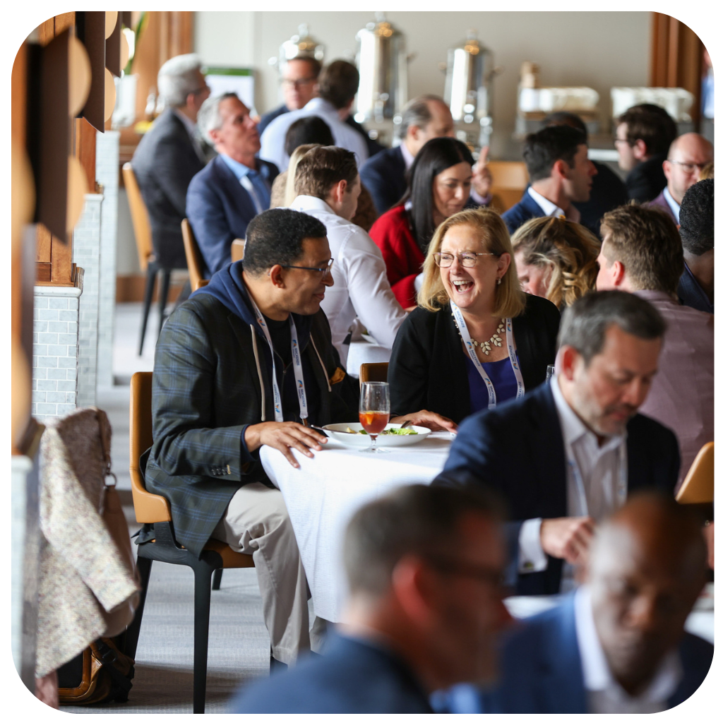 Allocators and managers shaking hands and networking at the Pension Bridge The Annual