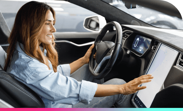 A woman uses the touch screen interface inside of an electric vehicle