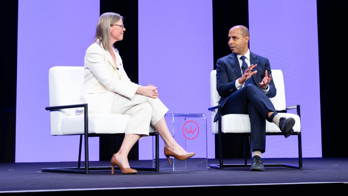 Photo of two speakers having a discussion on the main stage at The 2026 SUMMIT.
