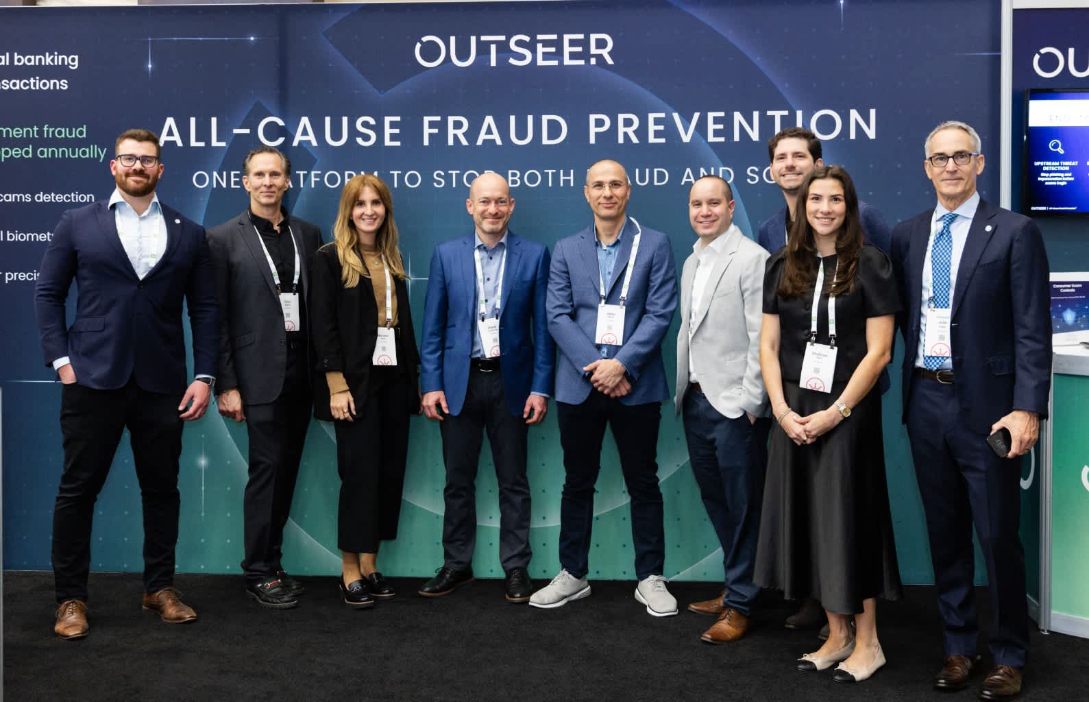 Photo of a sponsor delegation in front of their booth at The 2026 SUMMIT.
